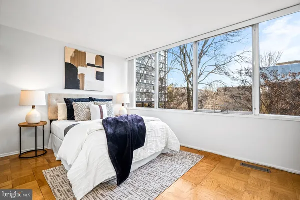 a bedroom with a large bed and a large window