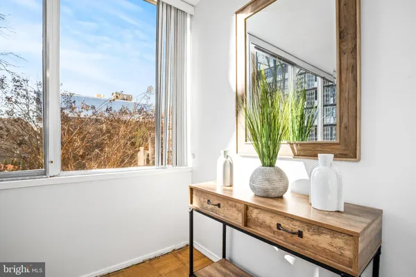 a view of a hallway with wooden floor and windows