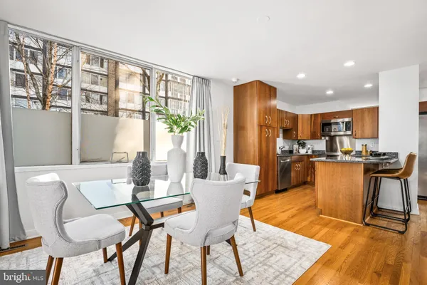 a dining room with furniture and wooden floor