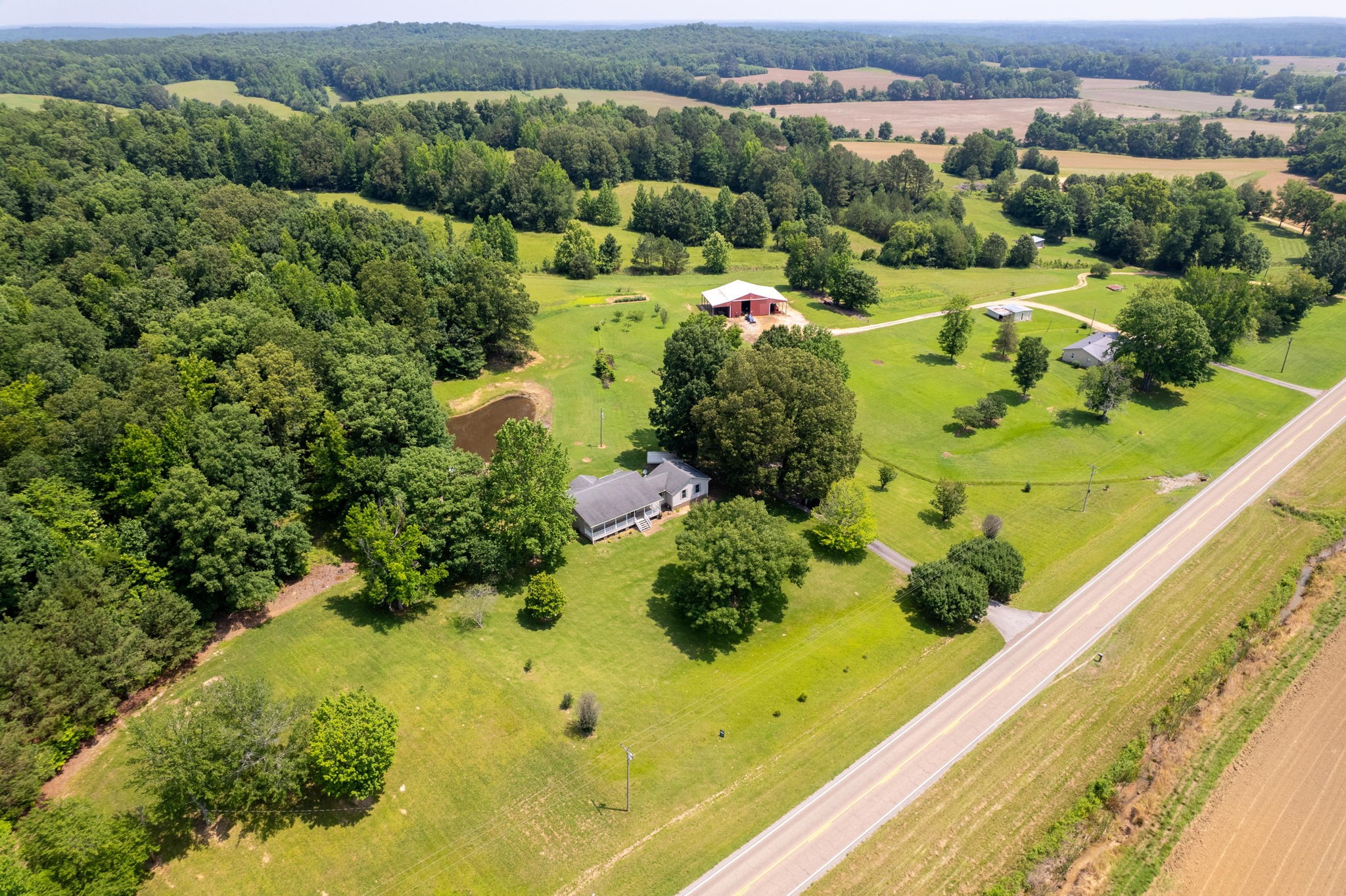 6675 Highway 100 Reagan, TN 38368 - Photo 24 of 32 a view of a garden with a building in the background