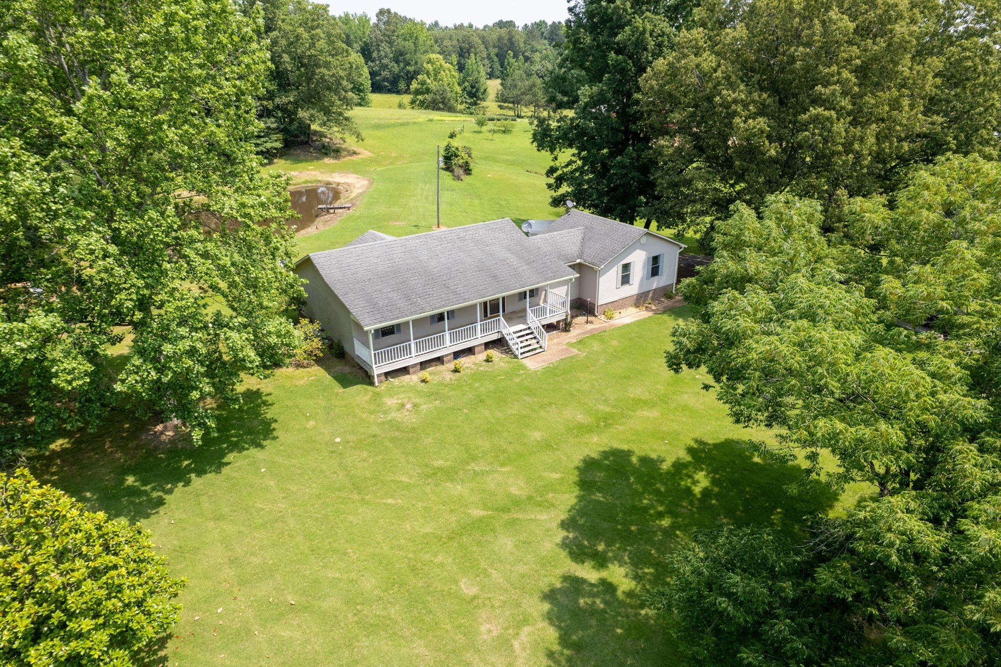 6675 Highway 100 Reagan, TN 38368 - Photo 25 of 32 a view of a house with a big yard and large trees