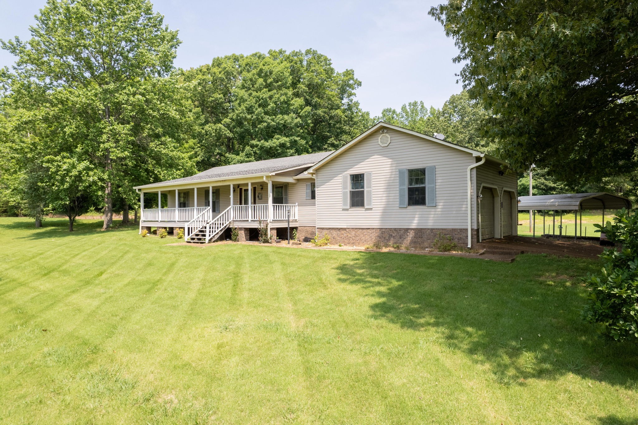 6675 Highway 100 Reagan, TN 38368 - Photo 27 of 32 a view of a house with a big yard and large trees