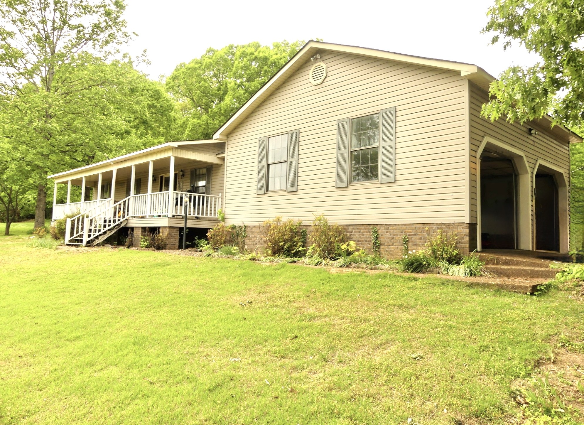 6675 Highway 100 Reagan, TN 38368 - Photo 29 of 32 a front view of a house with a garden