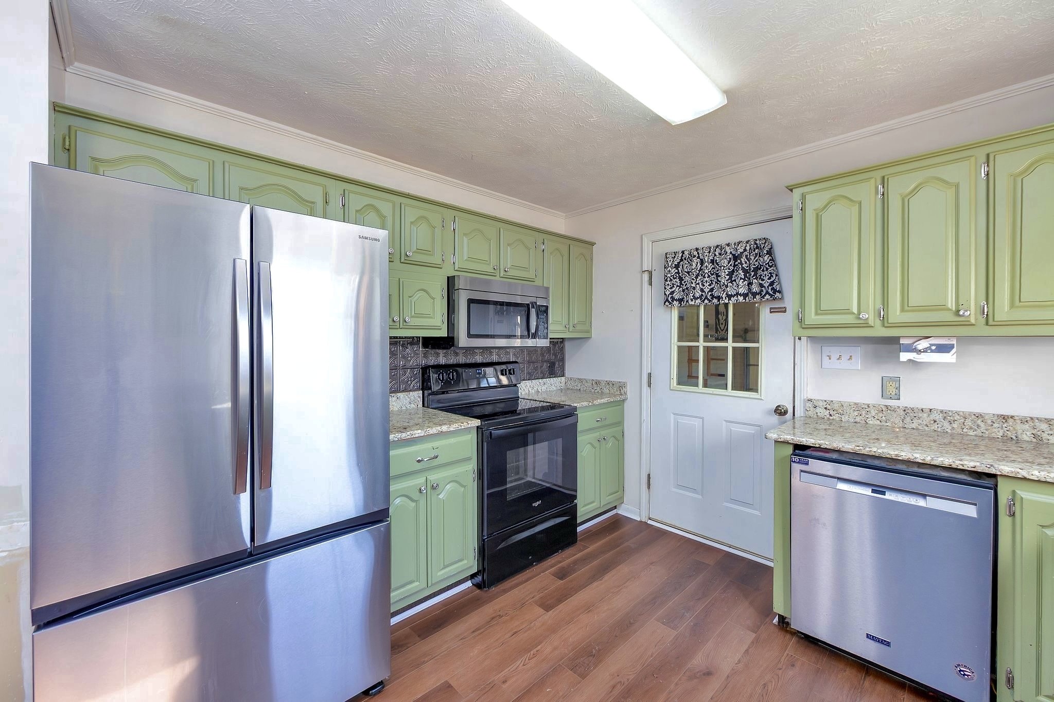 6675 Highway 100 Reagan, TN 38368 - Photo 6 of 32 a kitchen with stainless steel appliances granite countertop a refrigerator stove and sink