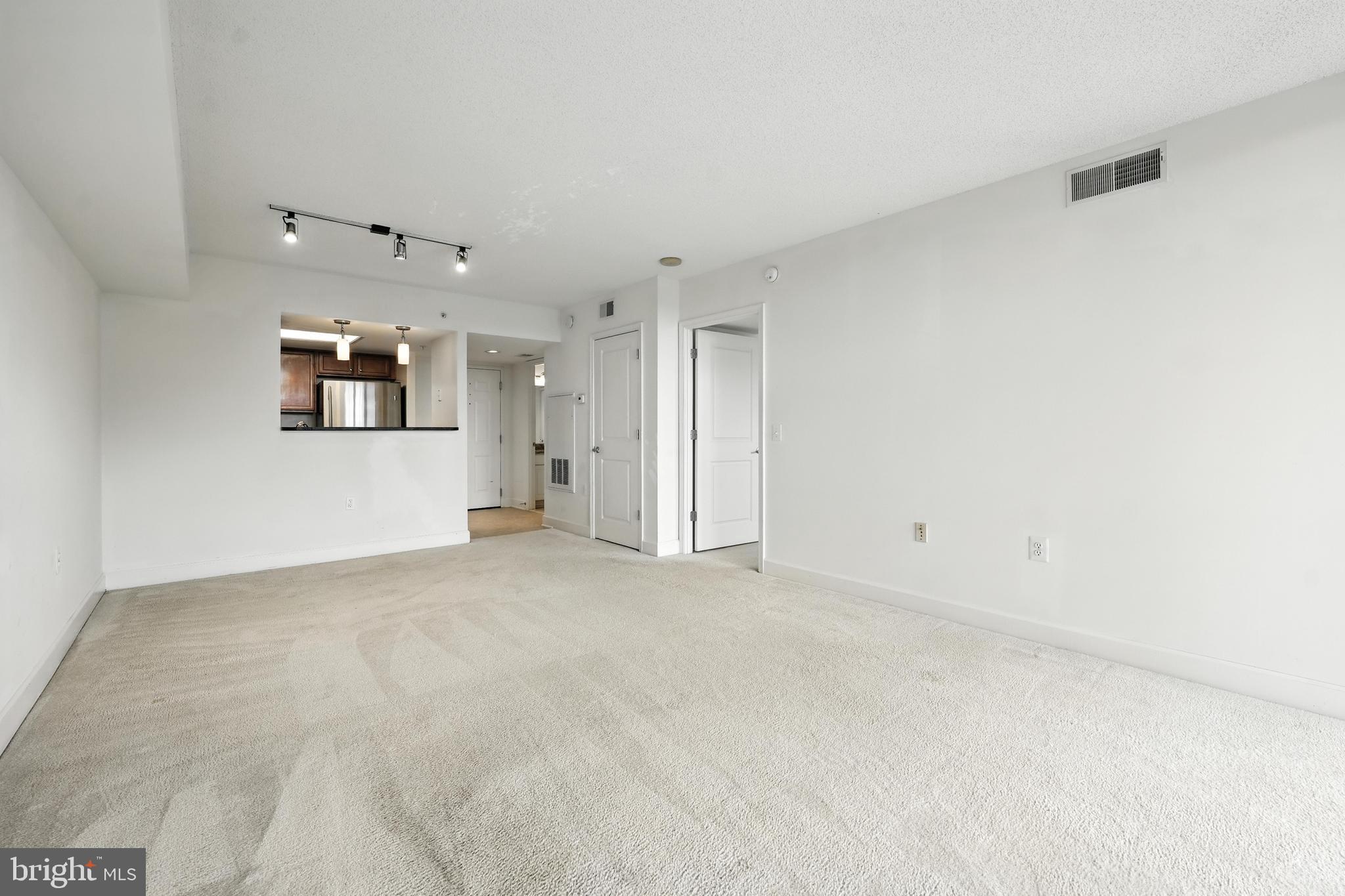 11800 Sunset Hills Road, Unit 818 Reston, VA 20190 - Photo 11 of 26 an empty room with chandelier fan