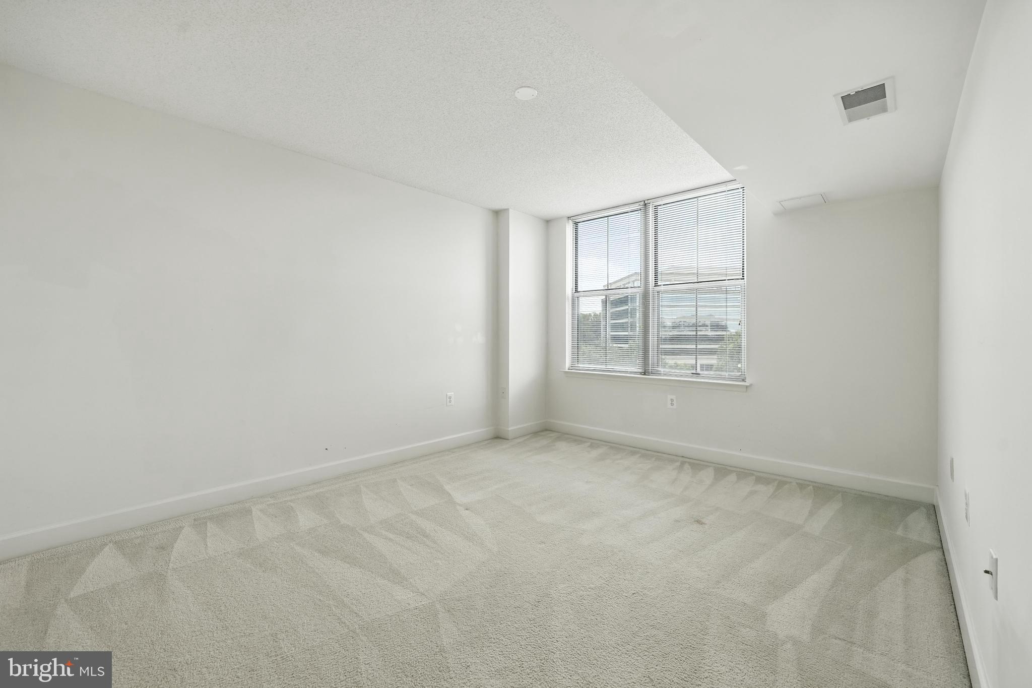 11800 Sunset Hills Road, Unit 818 Reston, VA 20190 - Photo 13 of 26 an empty room with windows