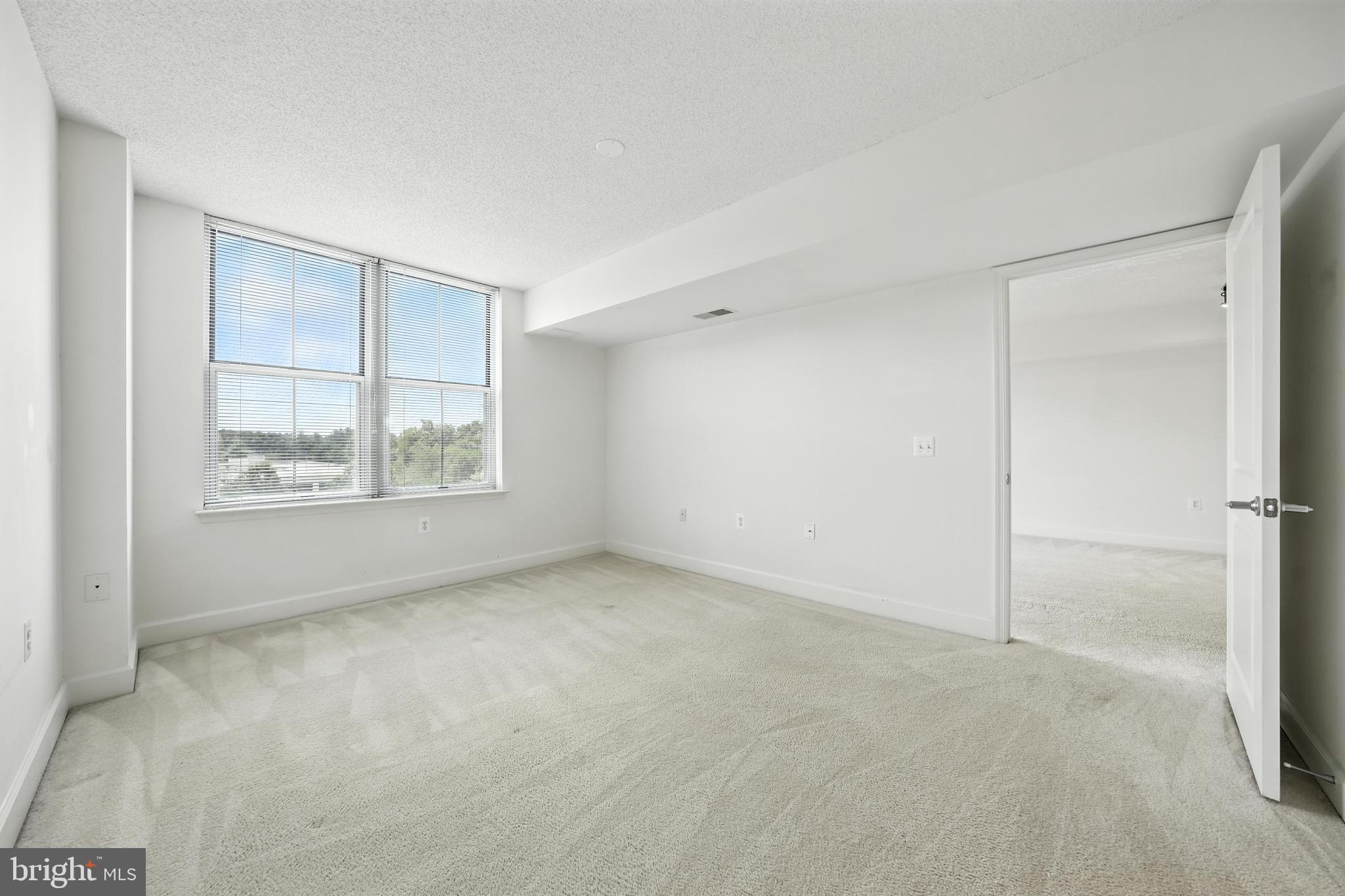 11800 Sunset Hills Road, Unit 818 Reston, VA 20190 - Photo 14 of 26 an empty room with windows and closet