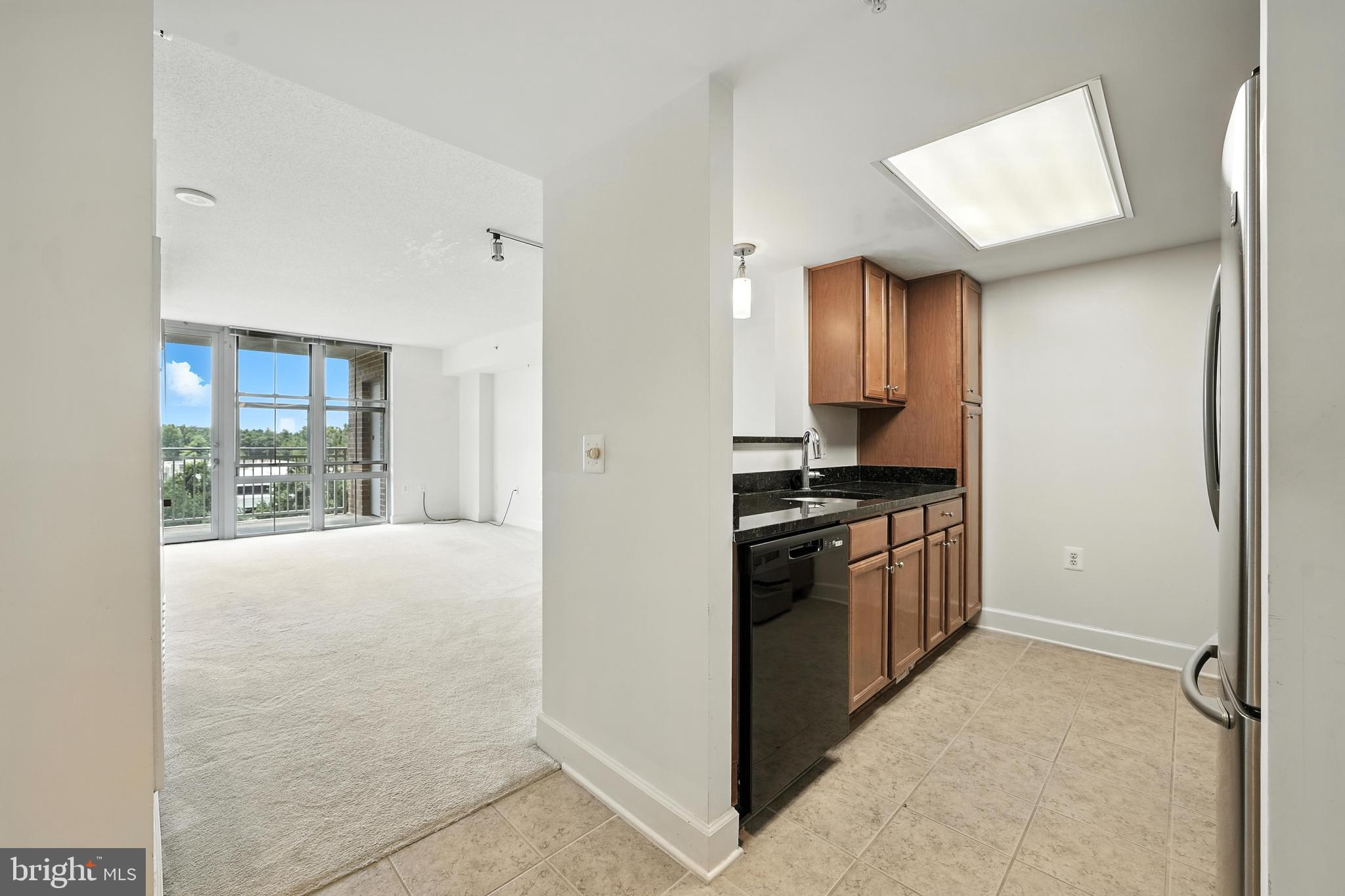 11800 Sunset Hills Road, Unit 818 Reston, VA 20190 - Photo 3 of 26 a kitchen with stainless steel appliances granite countertop a refrigerator and a stove