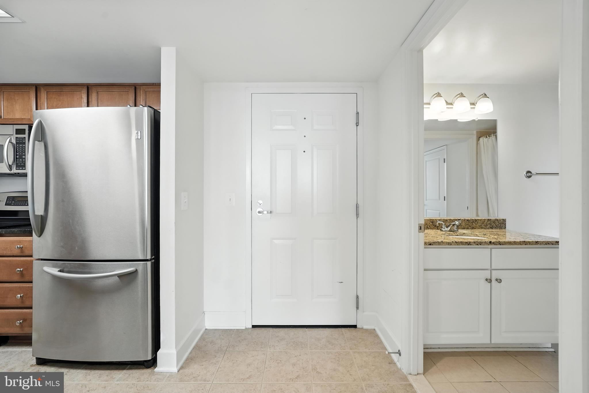 11800 Sunset Hills Road, Unit 818 Reston, VA 20190 - Photo 4 of 26 a refrigerator freezer sitting in a kitchen