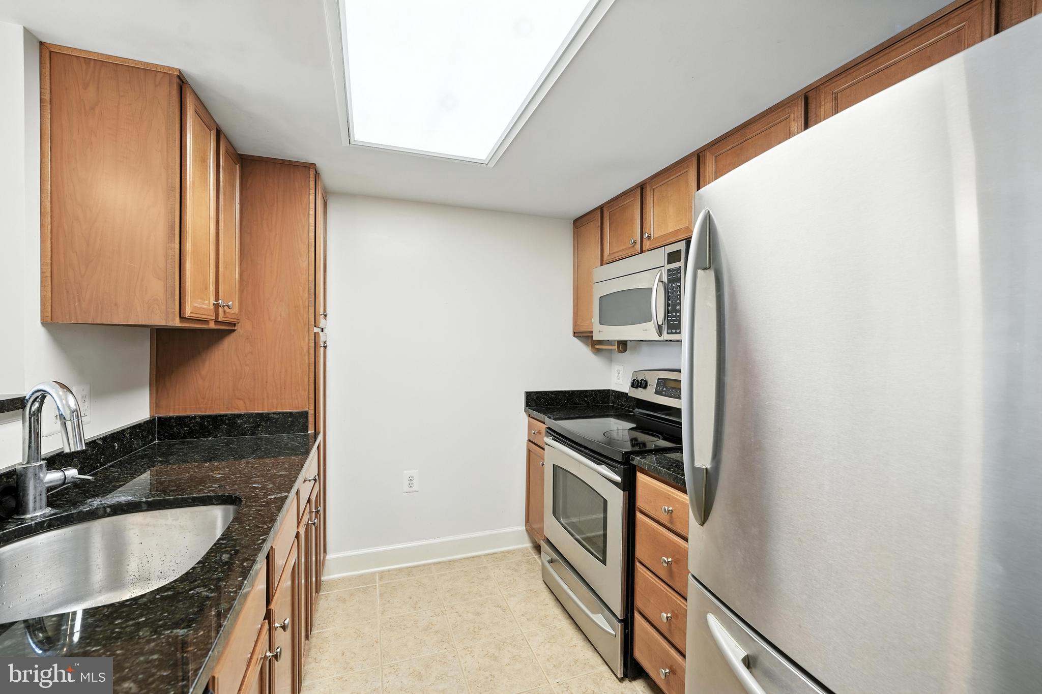 11800 Sunset Hills Road, Unit 818 Reston, VA 20190 - Photo 6 of 26 a kitchen with stainless steel appliances granite countertop a sink stove and refrigerator