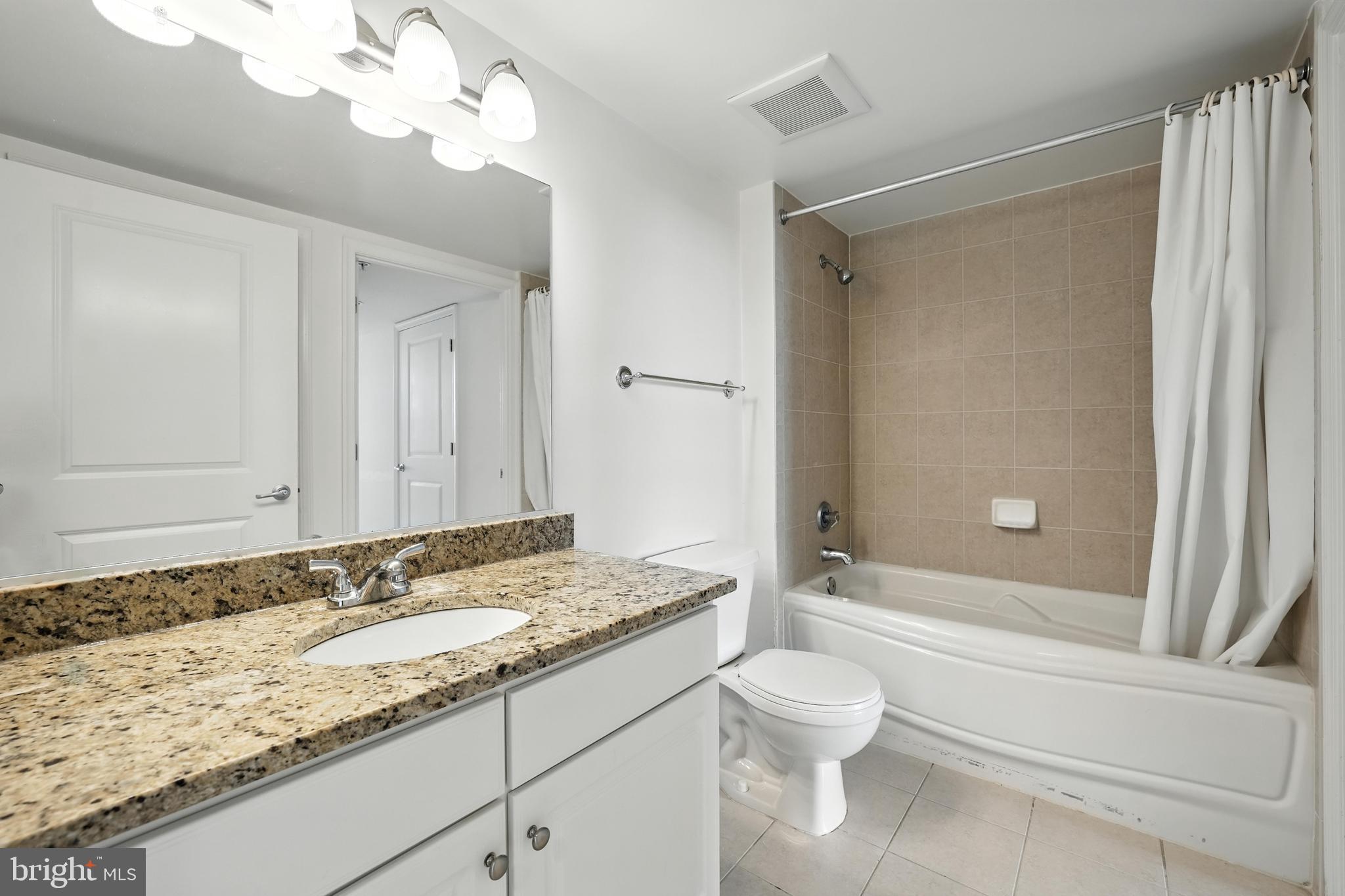 11800 Sunset Hills Road, Unit 818 Reston, VA 20190 - Photo 8 of 26 a bathroom with a granite countertop sink toilet and shower