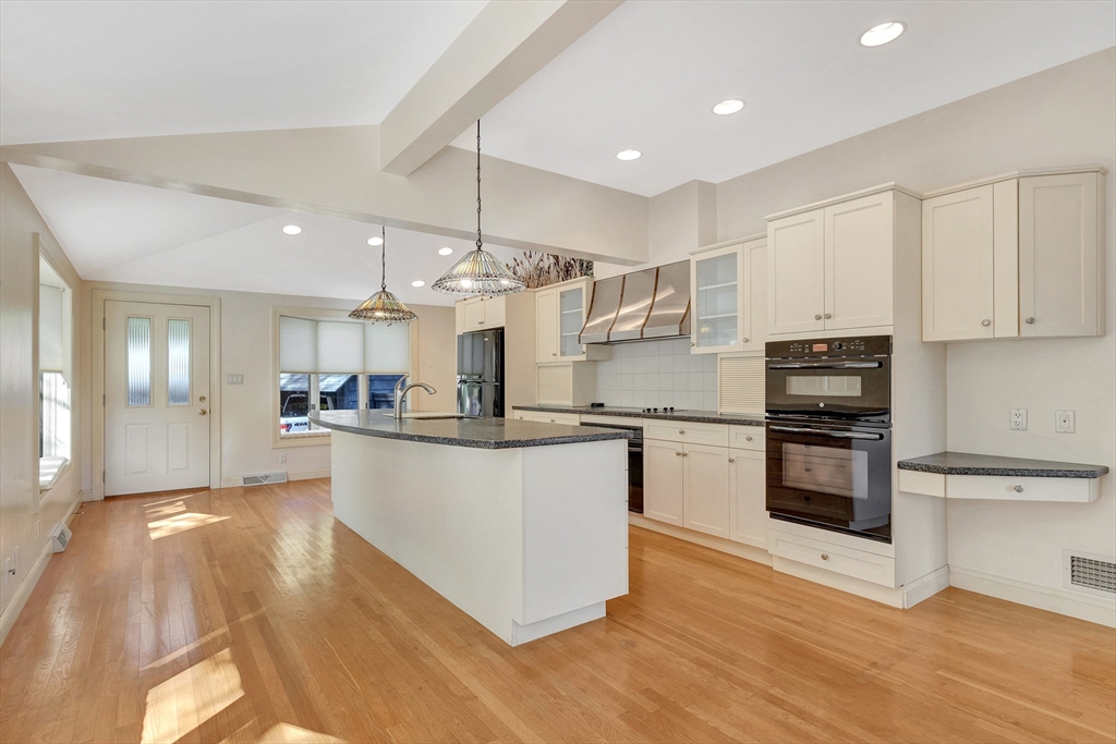 14 Pond Street Topsfield, MA 01983 - Photo 16 of 36 a kitchen with stainless steel appliances kitchen island granite countertop a stove a sink and white cabinets