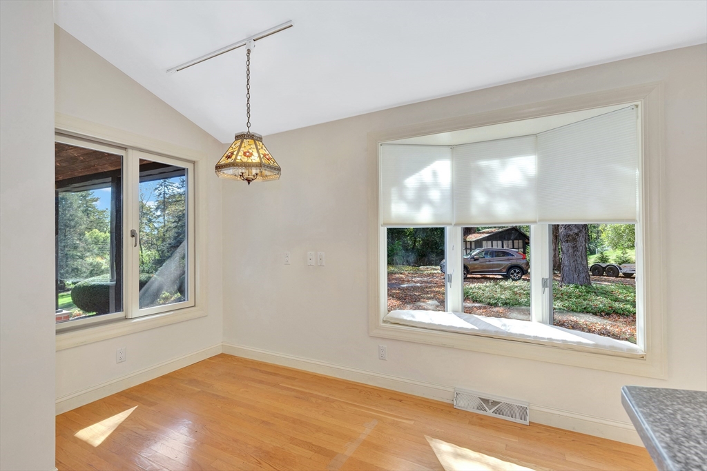 14 Pond Street Topsfield, MA 01983 - Photo 18 of 36 a dining room with a window and a chandelier