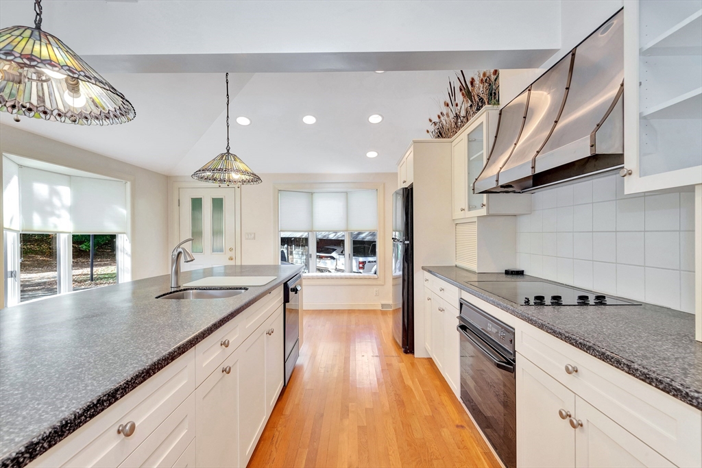 14 Pond Street Topsfield, MA 01983 - Photo 19 of 36 a large kitchen with stainless steel appliances granite countertop a lot of counter space and a wooden floors