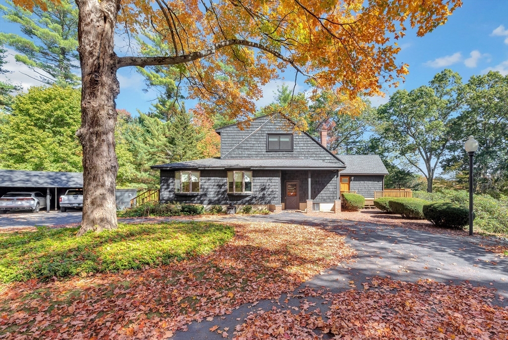 14 Pond Street Topsfield, MA 01983 - Photo 2 of 36 a front view of a house with a yard table and chairs