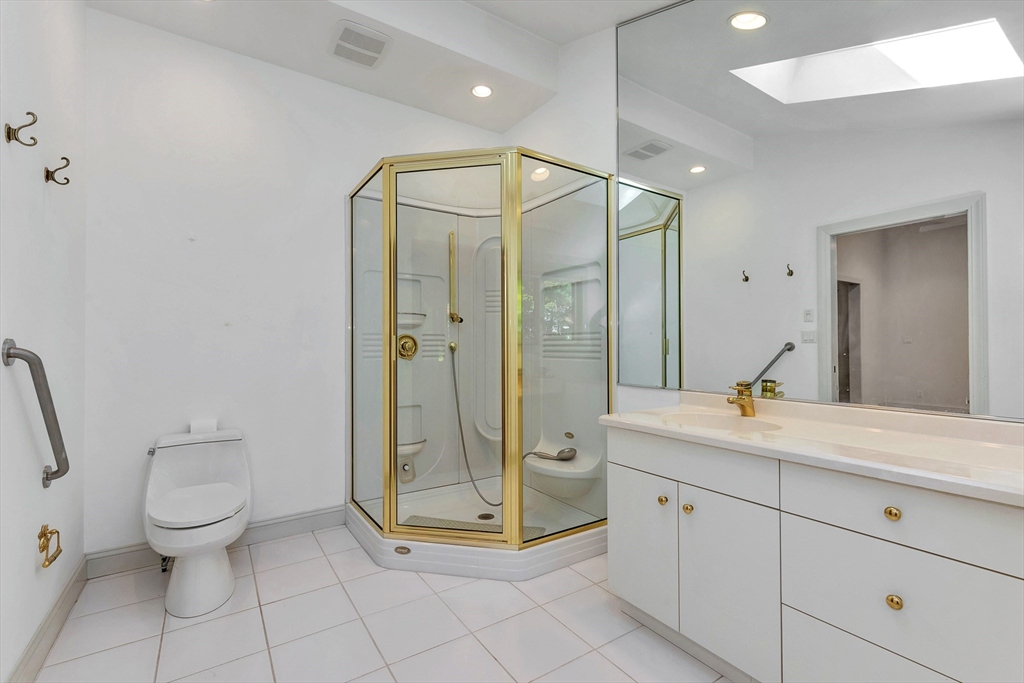 14 Pond Street Topsfield, MA 01983 - Photo 25 of 36 a spacious bathroom with a granite countertop sink a toilet and a mirror