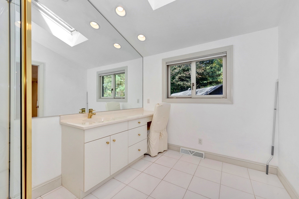 14 Pond Street Topsfield, MA 01983 - Photo 26 of 36 a view of a bathroom with two sinks and a window