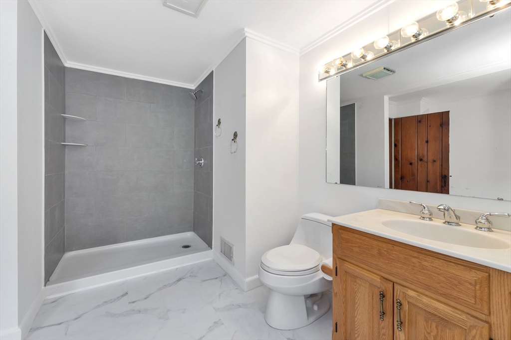 14 Pond Street Topsfield, MA 01983 - Photo 27 of 36 a bathroom with a sink a toilet and shower