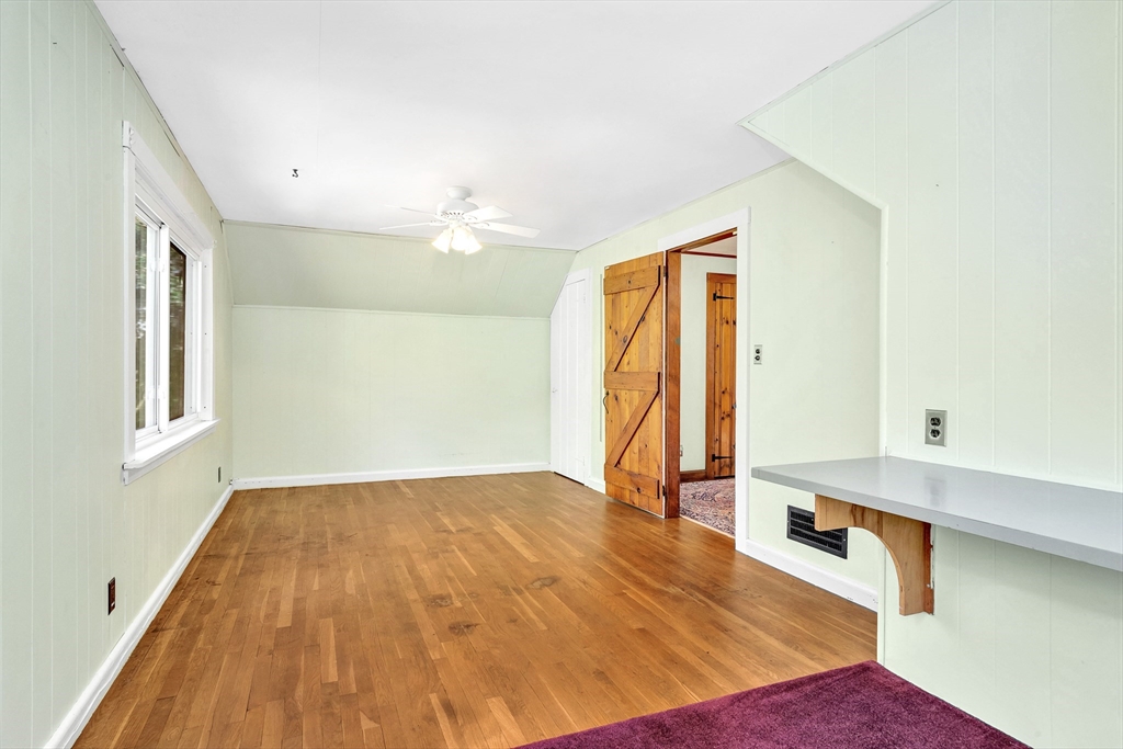 14 Pond Street Topsfield, MA 01983 - Photo 29 of 36 a view of an empty room with window and wooden floor