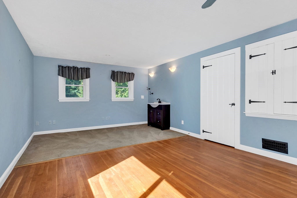 14 Pond Street Topsfield, MA 01983 - Photo 31 of 36 a view of an empty room with wooden floor and a window
