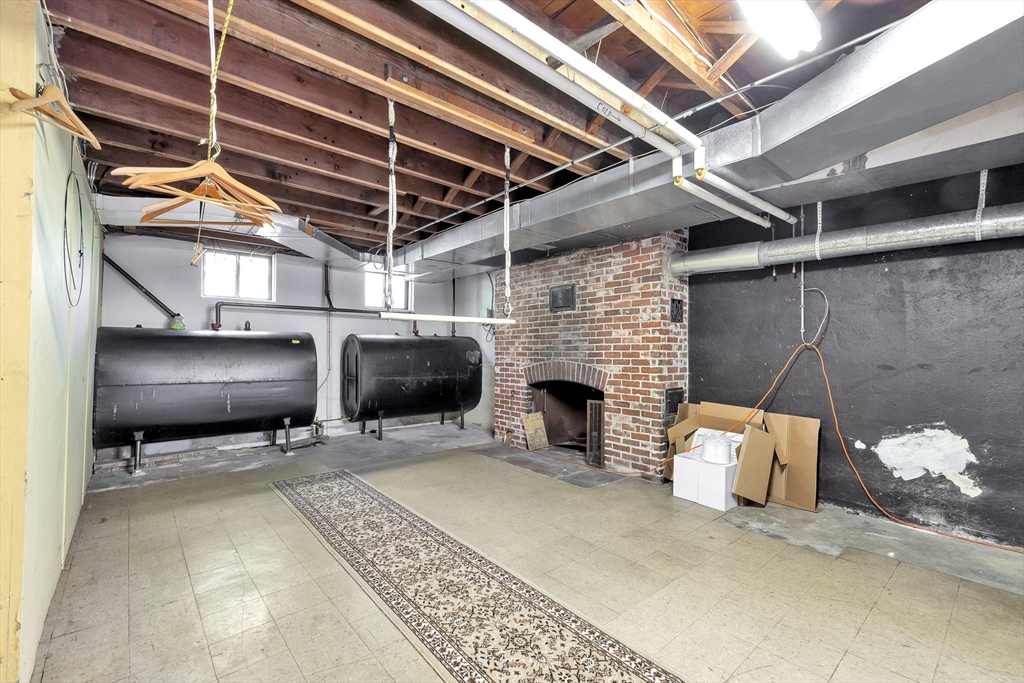 14 Pond Street Topsfield, MA 01983 - Photo 33 of 36 a view of a garage with chair and a fireplace