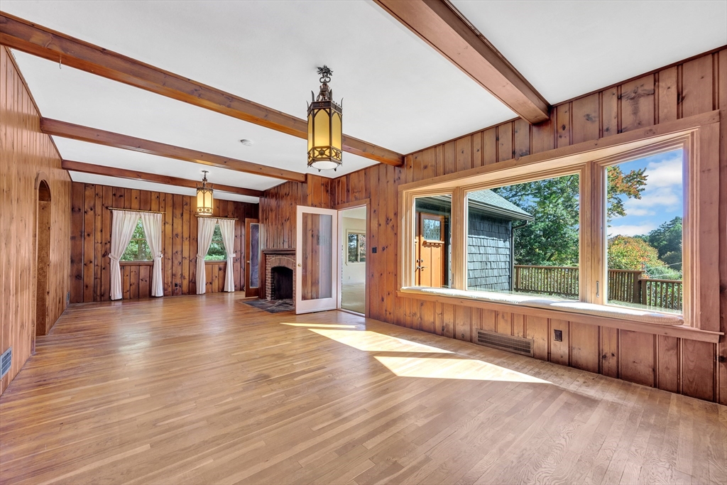 14 Pond Street Topsfield, MA 01983 - Photo 10 of 36 a view of an entryway with wooden floor fireplace and windows
