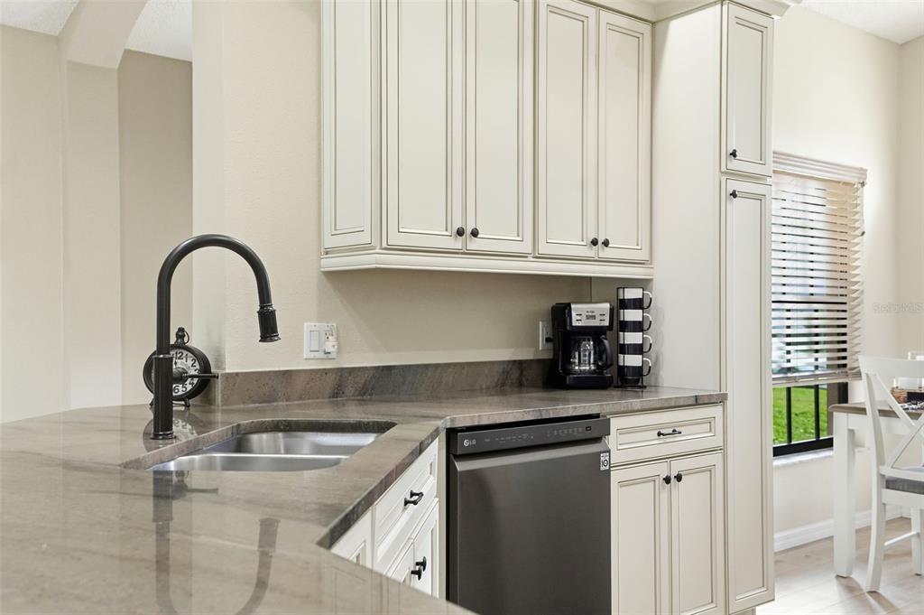 11437 Deercroft Court Spring Hill, FL 34609 - Photo 15 of 37 a kitchen with stainless steel appliances granite countertop a sink a stove and a window