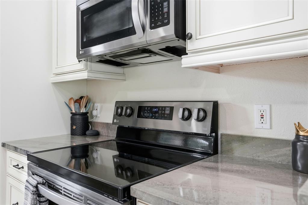 11437 Deercroft Court Spring Hill, FL 34609 - Photo 16 of 37 a kitchen with a stove and a microwave