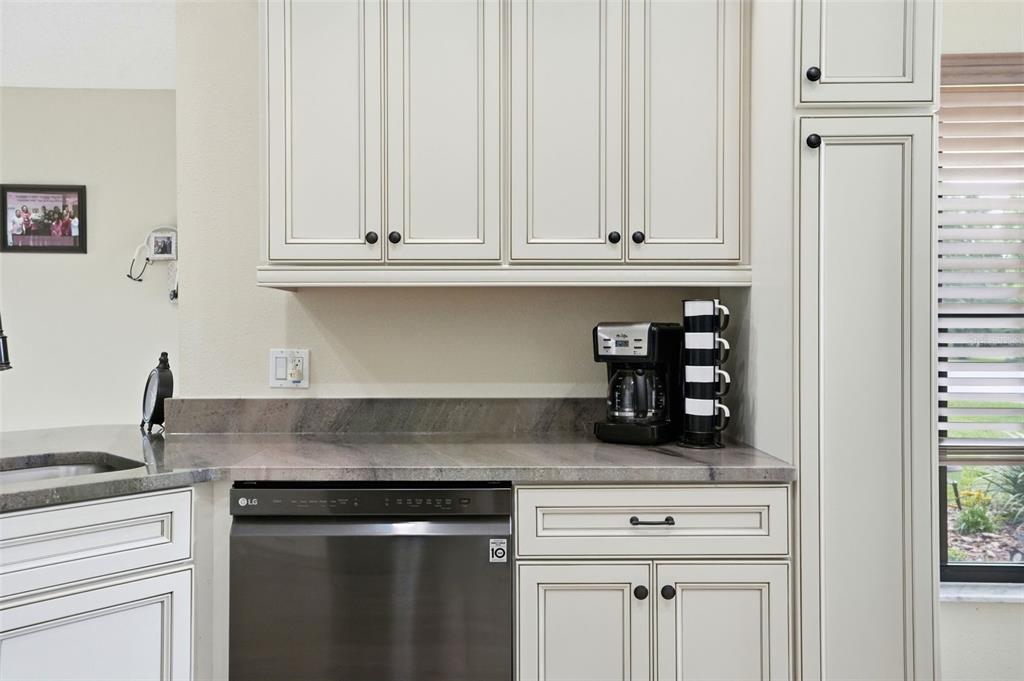 11437 Deercroft Court Spring Hill, FL 34609 - Photo 17 of 37 a kitchen with granite countertop white cabinets and sink