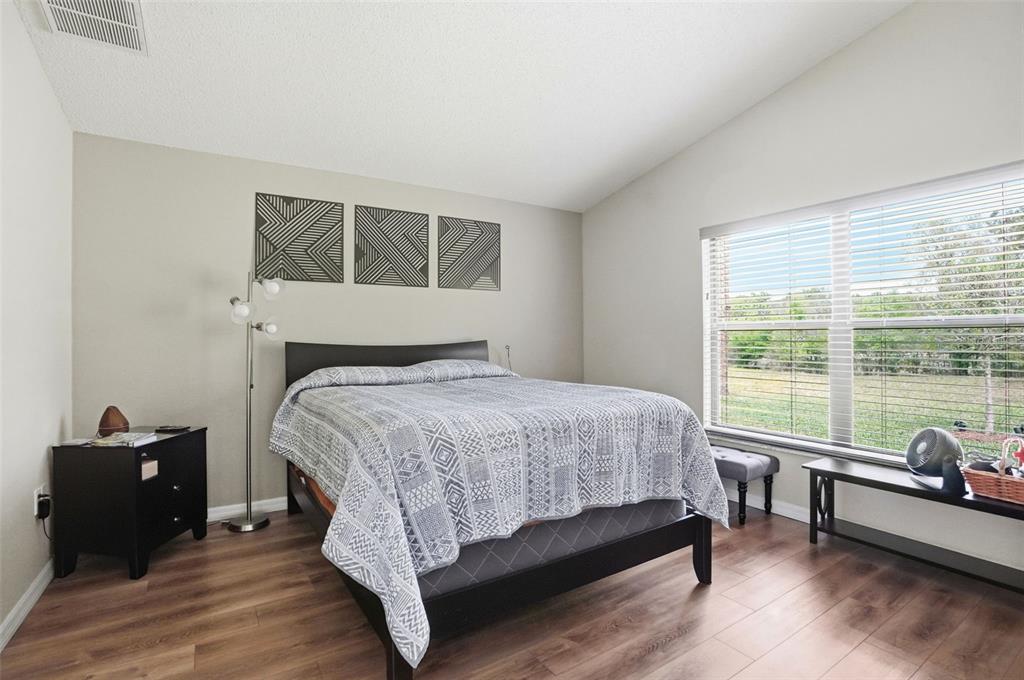 11437 Deercroft Court Spring Hill, FL 34609 - Photo 20 of 37 a bed sitting in a bedroom next to a window
