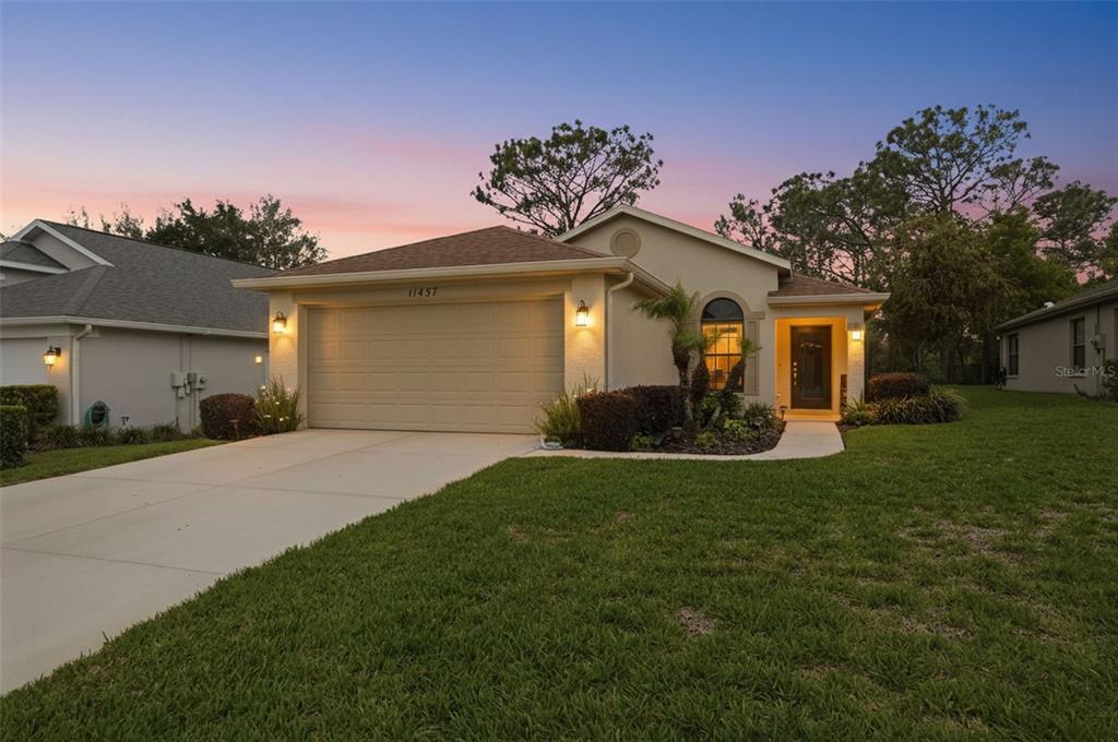 11437 Deercroft Court Spring Hill, FL 34609 - Photo 2 of 37 a front view of a house with a yard and garage