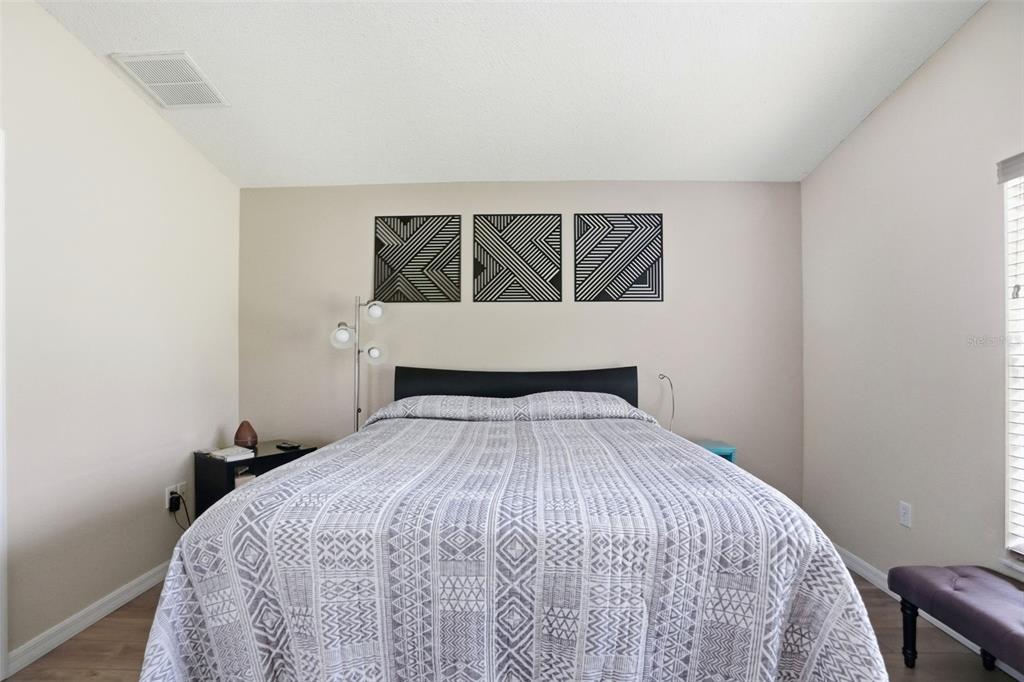 11437 Deercroft Court Spring Hill, FL 34609 - Photo 21 of 37 a bed sitting in a bedroom next to a window