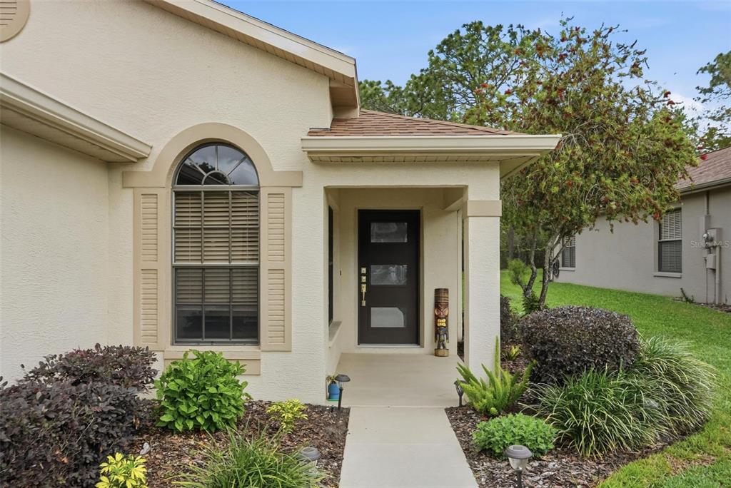 11437 Deercroft Court Spring Hill, FL 34609 - Photo 4 of 37 a front view of a house with garden