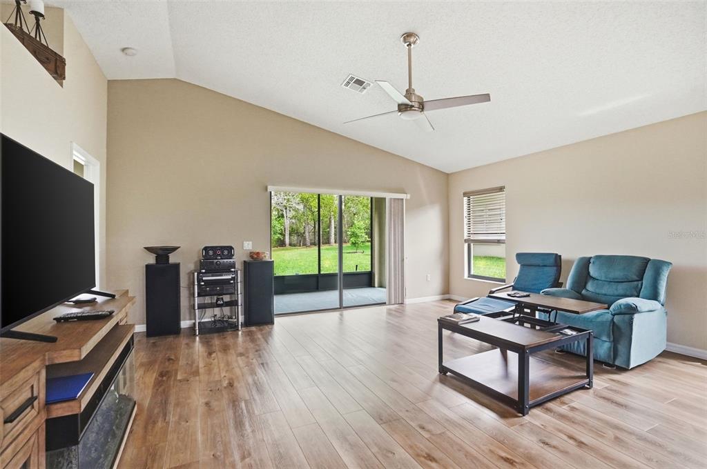 11437 Deercroft Court Spring Hill, FL 34609 - Photo 5 of 37 a living room with furniture and a flat screen tv