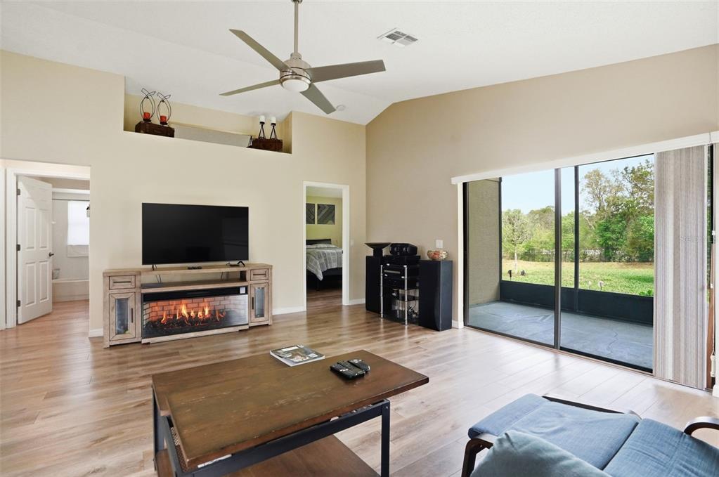 11437 Deercroft Court Spring Hill, FL 34609 - Photo 7 of 37 a living room with furniture a flat screen tv and a large window