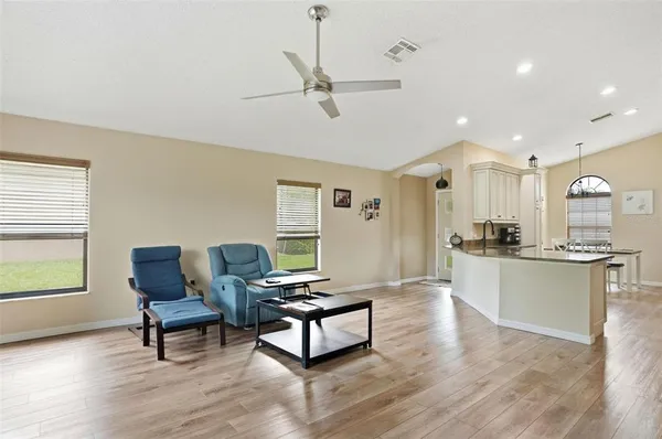 a living room with furniture and a wooden floor