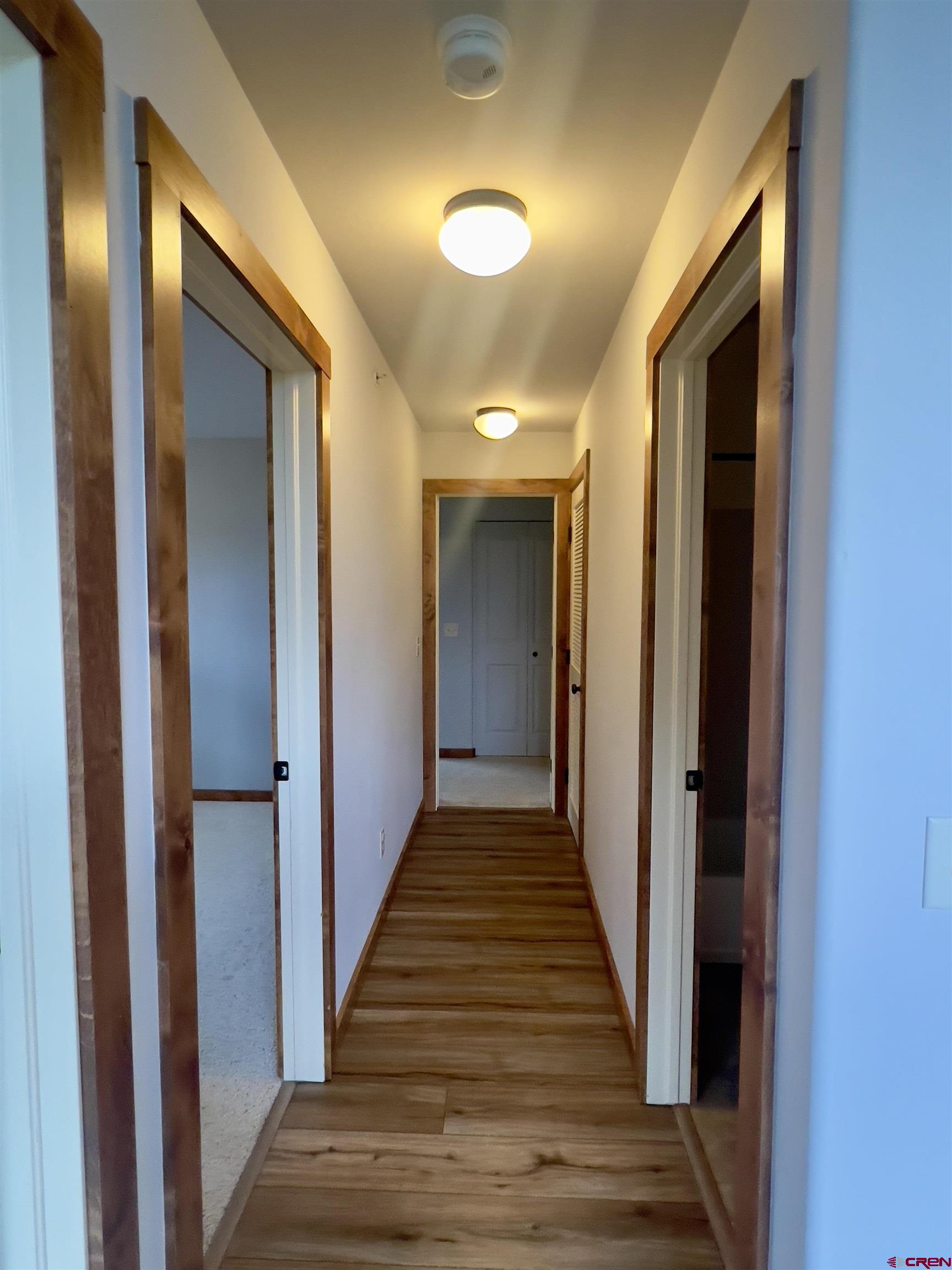 540 Redcliff Circle, Unit E 203 Ridgway, CO 81432 - Photo 26 of 36 a view of a hallway with wooden floor and staircase