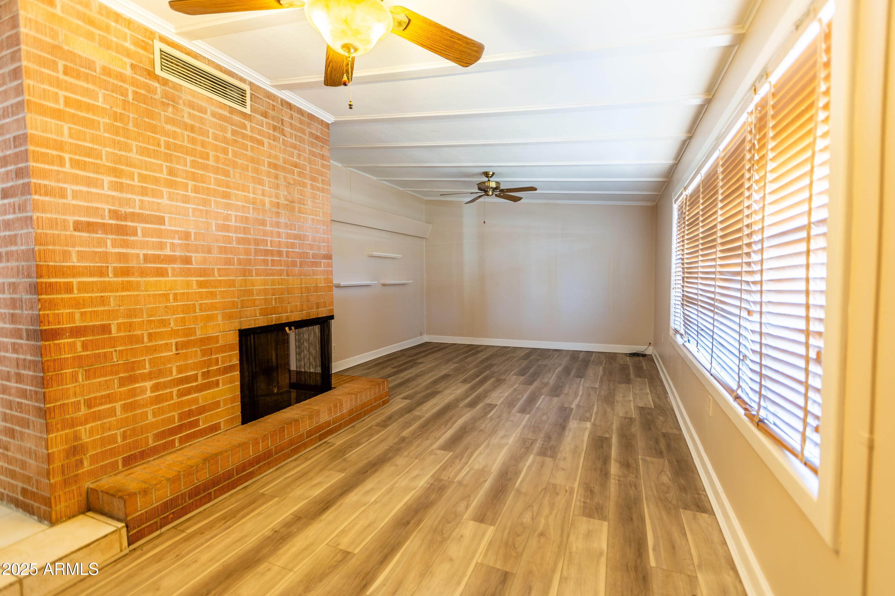412 Fairhaven Road Kearny, AZ 85137 - Photo 11 of 36 a view of empty room with wooden floor and fan