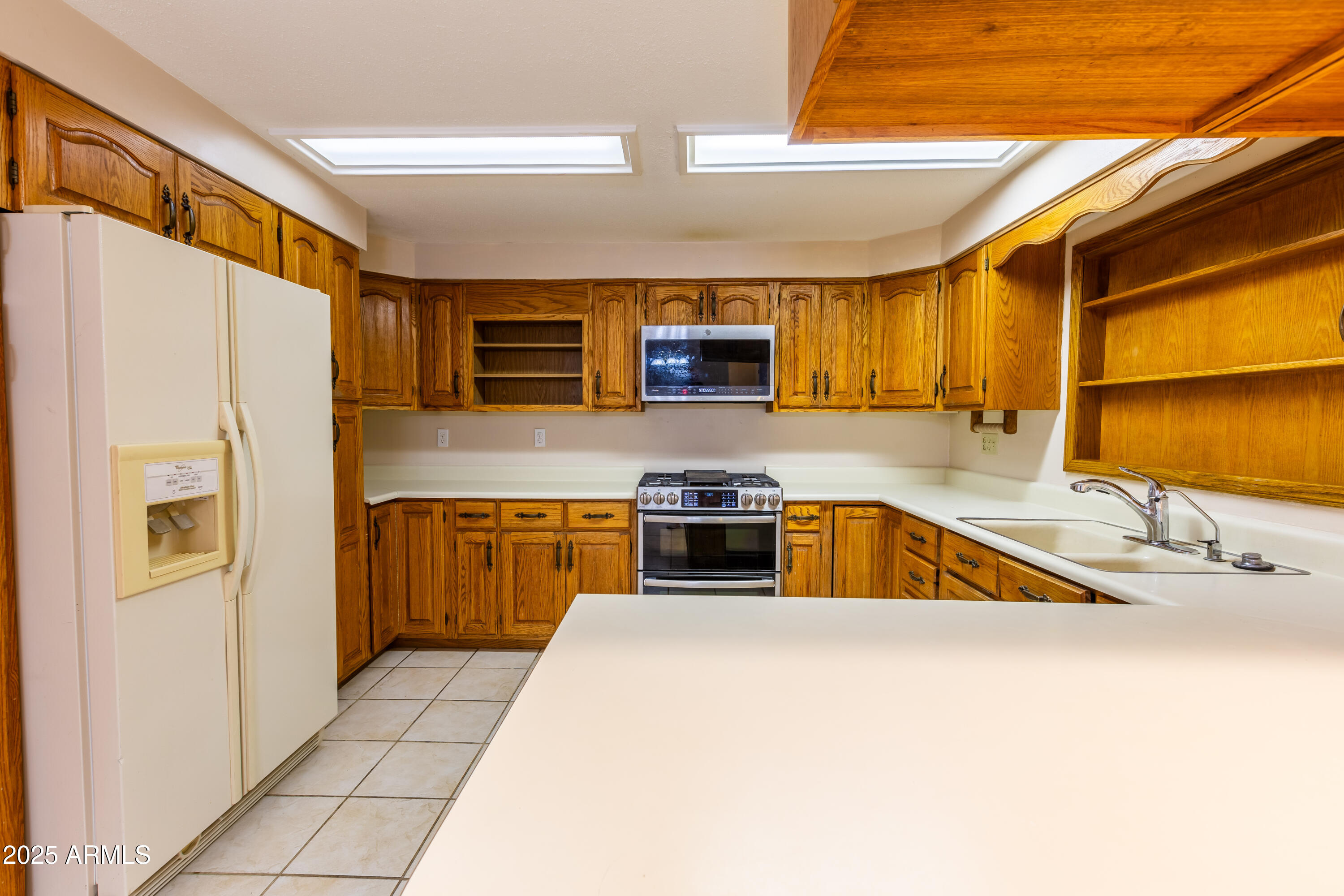412 Fairhaven Road Kearny, AZ 85137 - Photo 17 of 36 a kitchen with stainless steel appliances granite countertop a sink and a refrigerator