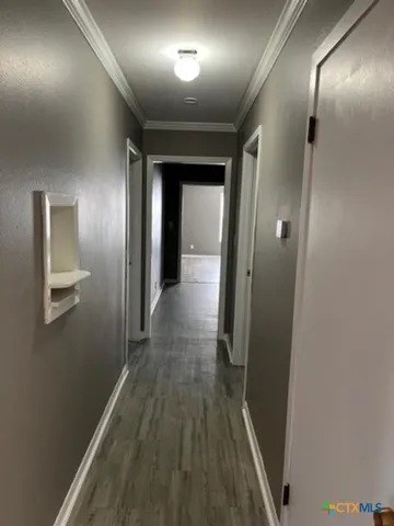 a view of hallway with wooden floor