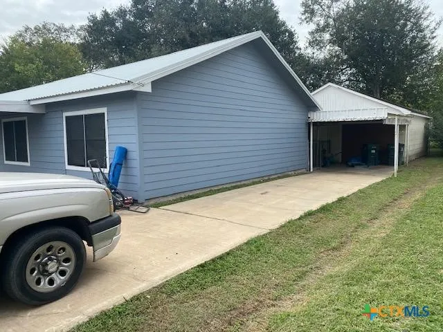 a view of garage with a car parked in it