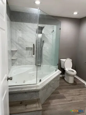 a bathroom with a bathtub and a shower