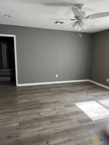 a view of a room with wooden floor