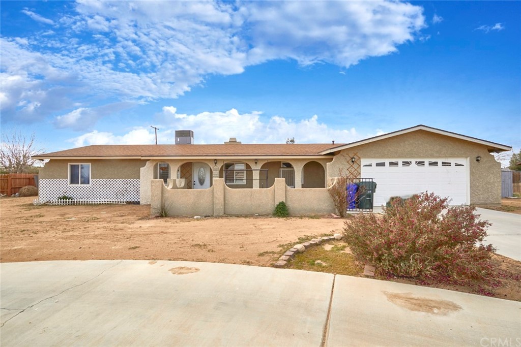 12402 Tesuque Road Apple Valley, CA 92308 - Photo 1 of 1 a front view of a house with a yard