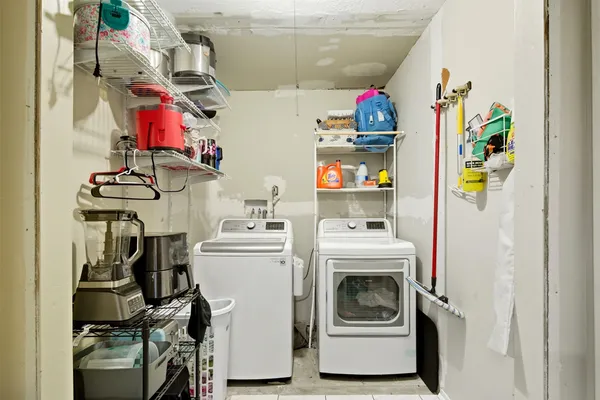 a utility room with dryer washer and other items