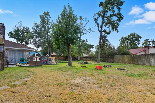 a view of a house with a yard and sitting area