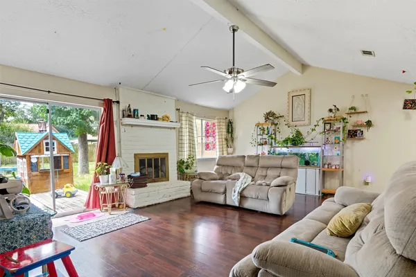 a living room with furniture fireplace and a large window