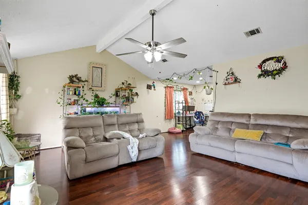 a living room with furniture and a chandelier