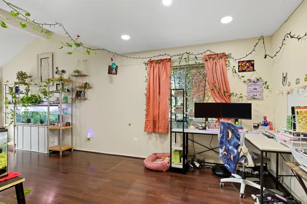 a view of a room with lots of stuff and hardwood floor