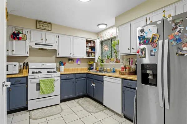 a kitchen with refrigerator and cabinets